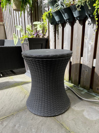 Patio table with adjustable height and a cooler bucket.
