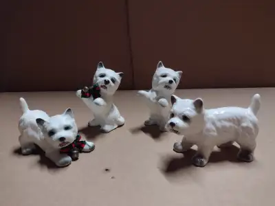 Dog Figurines. 2 with ribbons are Genuine Bone China 2 others are Bone China Taiwan. All sitting up...