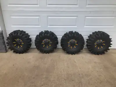Deep lug Terminator tires mounted on BRP rims. Used but barely worn. Minor checking but no plugs or...
