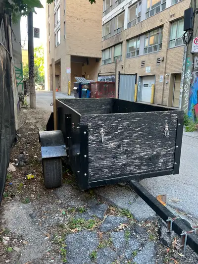 This robust utility trailer is good for hauling - large wheels, good condition. Has a stand to raise...
