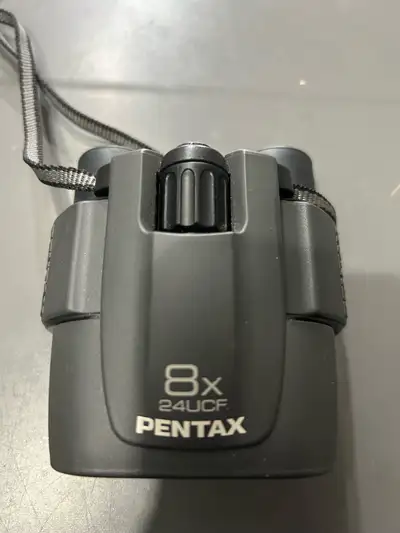Discover the world up close with these Pentax 8x24 UCF binoculars! These compact binoculars are in g...