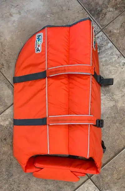 Keep your furry friend safe during water adventures with this orange Top Paw dog life jacket, Specif...