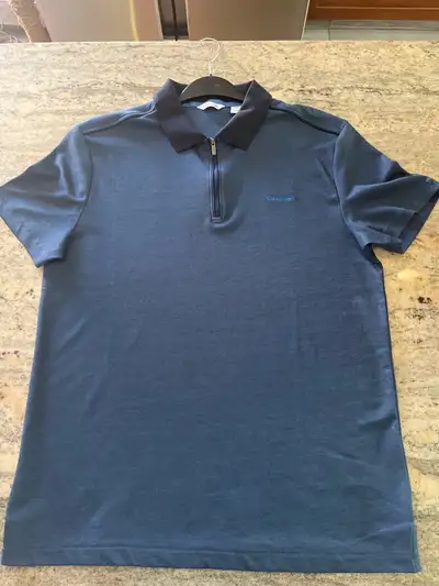 New without tags, stylish men's Calvin Klein polo shirt, featuring a quarter-zip design and crafted...
