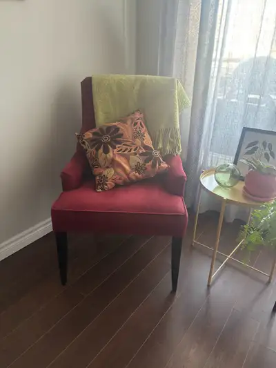 Add a pop of colour to your living space with this stylish red accent chair! This chair features a s...