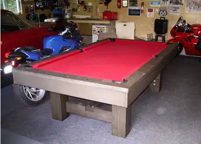 This is an 8-foot pool table with a slate bed, disassembled and ready for easy transport. The table...