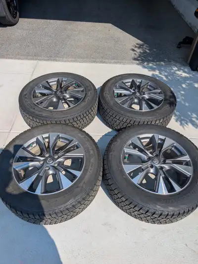 These high-quality, pre-owned Bridgestone Blizzak DM-V2 winter tires, sized 235/65R18, are mounted o...