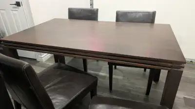In good condition. Solid wood dining table and 4 leather chairs. Legs come off for easy transport.