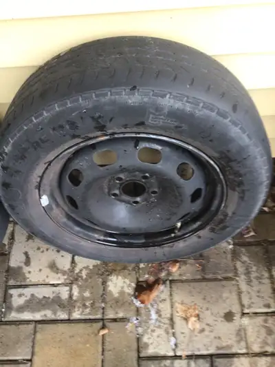2 older tires on rims. Platforms with casters for stacking tires for storage