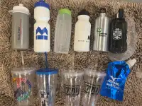 Variety of water bottles and cups with lids and straws
