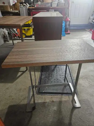 Wooden with stainless steel legs very sturdy can be used as side table.