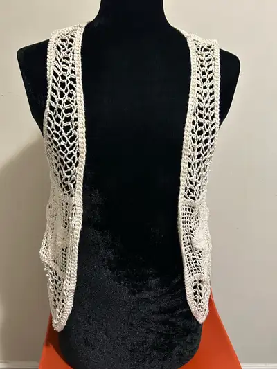 This is a cream-coloured, crocheted women's vest, perfect for layering and adding a touch of handmad...