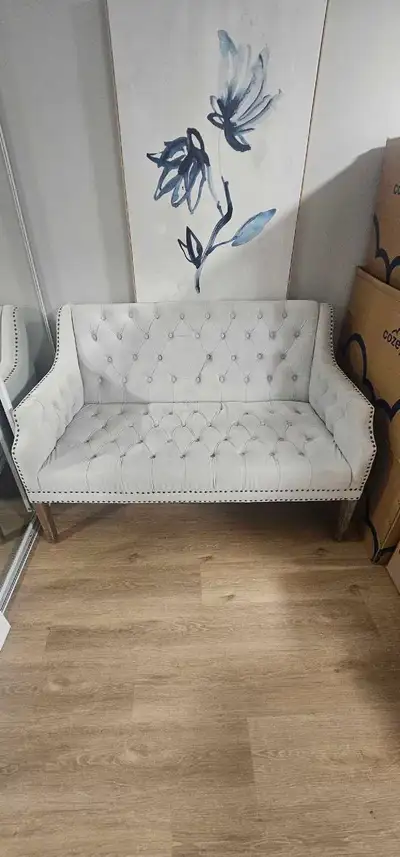 This item was only used for staging homes business. This elegant loveseat, with its button-tufted de...