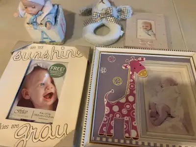 Two 4x6 photo frames. One 2x3 photo frame. One soft puppy rattle. One wind-up music box that plays “...