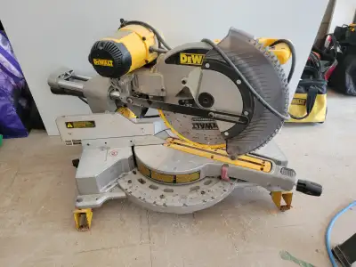 DeWalt 12" sliding mitre saw. Model DWS709. Comes with adjustable stand. Model DW723. Both pieces in...