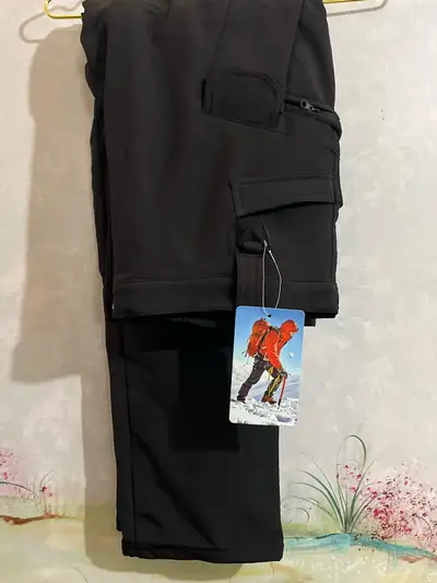 I am selling a brand new pair of black outdoor hiking pants, perfect for any adventure with their du...