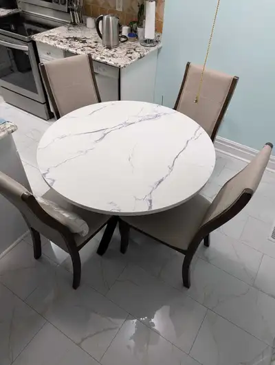 Round dining table including four chairs, all in excellent condition. 3 years old and original value...