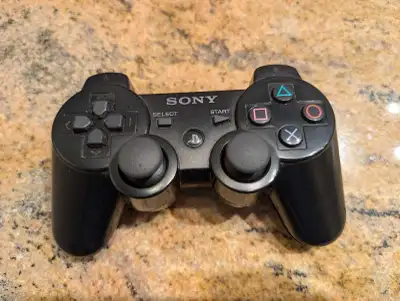 Selling a used black Sony DualShock 3 controller, specifically for parts. The controller shows signs...