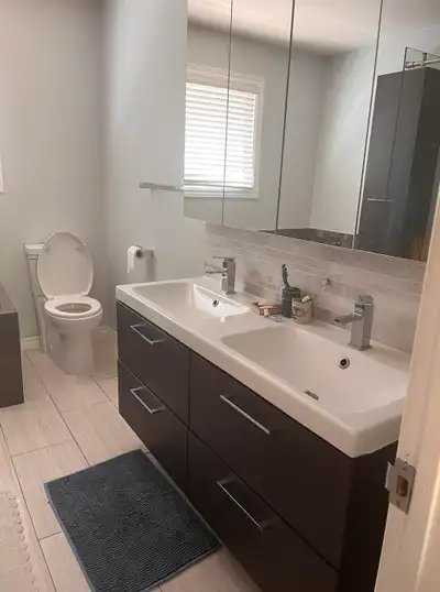 A room with an ensuite bathroom facing a beautiful back