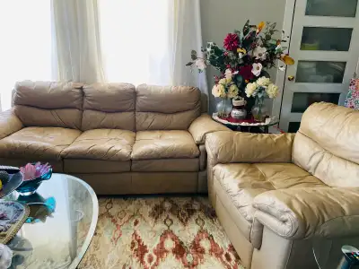 This is a comfy, used leather sofa with a chair perfect for a family room. Please note that it is in...
