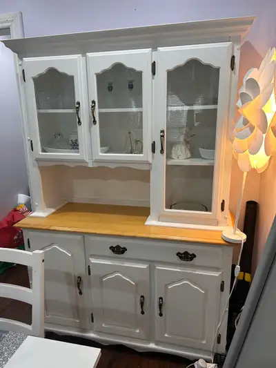 Beautiful solid wood buffet and hutch for sale with glass windows. Lots of storage at the bottom.