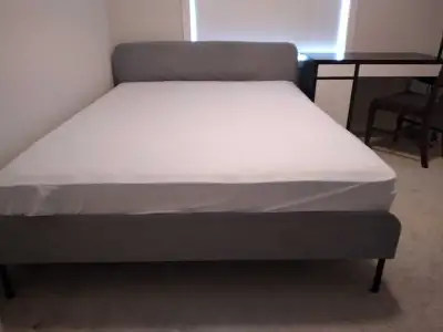Selling a queen-size bed frame with mattress in great condition. The frame has a modern grey upholst...