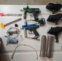 Two paintball markers and accessories