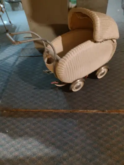 Antique doll Pram, New England. Hub cap wheels. The undercarriage needs adjusting & repair on the in...
