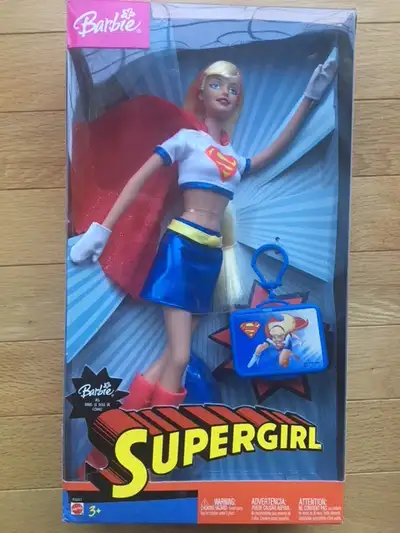 Vintage Barbie SuperGirl Supergirl - is dressed in a blue vinyl mini-skirt and a short white top wit...