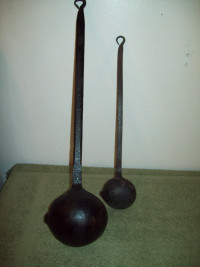 Antique pair cast iron ladles black