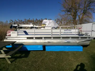 The pontoon boat is an 18' Manitou. It has a Mariner 2 stroke motor. The pontoons are in pretty good...