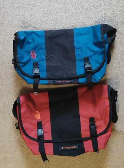2 new Classic-style timbuk2 messenger bags with chest strap. One in Blue/Black and one in Red/Black....
