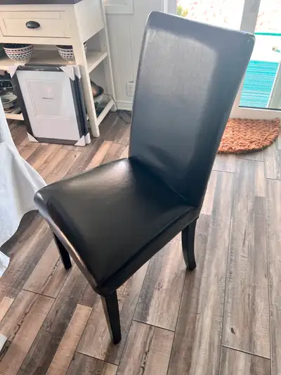 Six (6) leather dining room (Parson style) chairs with white slip covers.