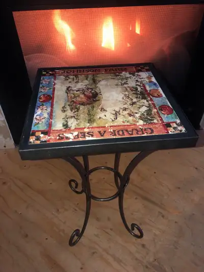 This is a used accent table featuring a Johnson Farm themed top. It shows signs of wear, which adds...