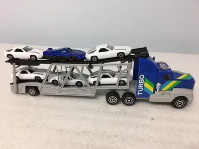 8 Wheel Toy Turbo Car Carrier; 6 cars included. Measures 14" in length; 3.5" in height. Moveable par...