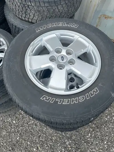 Set of 4. Tires have tread but are older. 235/70/16