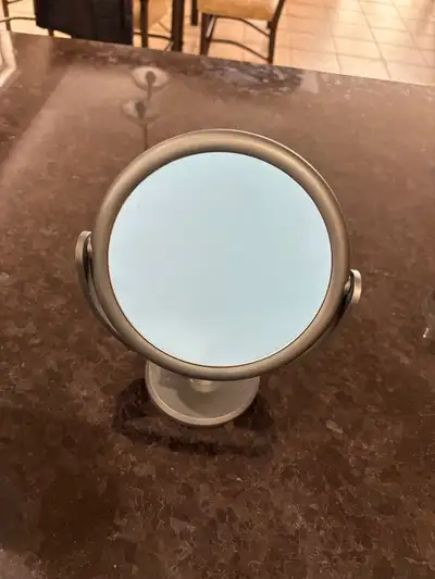 Two sided mirror, one side magnified. Great to apply makeup or to pluck hair with.