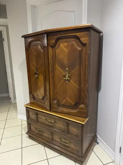 This vintage armoire offers both style and functionality for your storage needs. With its distinctiv...