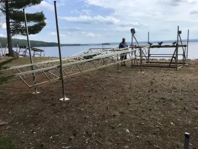 1800 pound boat lift with Strong Arm Motor, complete with pulleys, bunks and cables, all in good con...