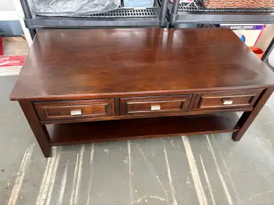 Solid wood coffee table with three drawers. 4 foot long, almost 2 foot long and 19 inches tall. $250...