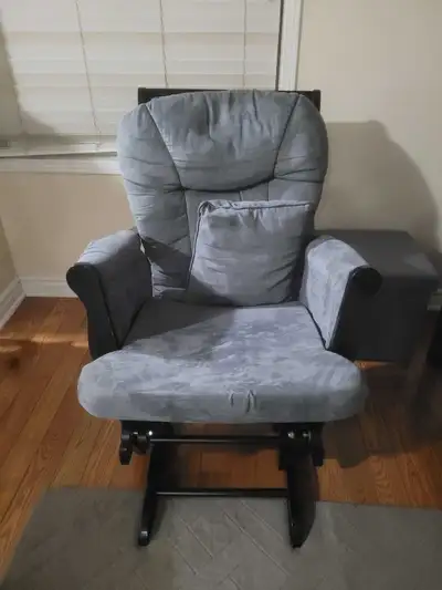 Selling a comfy grey glider rocking chair with a matching ottoman! It's in great condition and perfe...