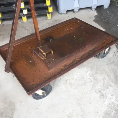 ON 8 INCH CASTERS - 46 1/2 LONG - 30 DEEP - 10 INCHES TALL - MIGHT HAVE BEEN USED TO PUT WELDING MAC...