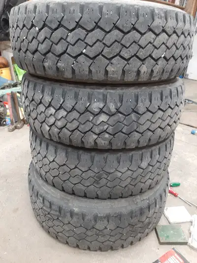ONE SET IS 80% PLUS THE OTHER IS AROUND 70% IF YOU WANT A GOOD WORK/BUSH TIRE THESE ARE IT FLATS ARE...