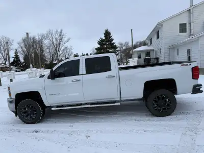 Offering auto body work services. The images show rust repair and a fresh coat of white paint on a t...