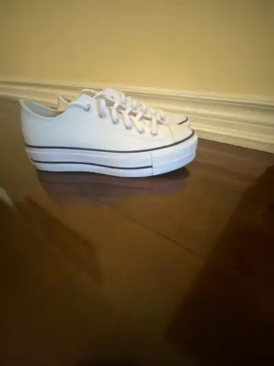 Women's white platform Converse sneakers. Low-top style, lace-up closure. Clean, classic design. Gre...