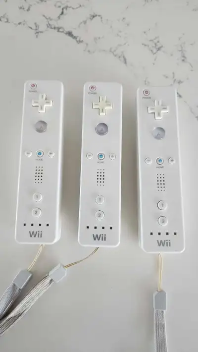 These are three Nintendo Wii remotes that are compatible with the Nintendo Wii. These are used and i...