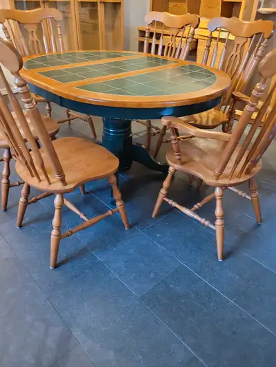 Solid wood table and 6 wooden chairs 4 regular chairs and 2 Captin chairs with arms. Table seats six...