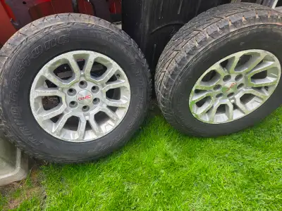 4 Bridgestone Dueler A/T P275/65R18 Rims Have a few marks and tires have wear for more info call to...