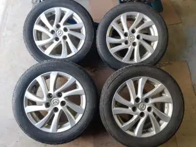 Used set of 4 Cooper CSS Grand Touring M+S 205 / 55 R16 On set of 5bolt Mazda 3 rims. Lots of tire t...