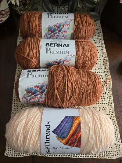 A mix of 3+ (7 oz) skeins of Bernat Premium in caramel colour and 1 (7oz) skein of Peach (flesh colo...