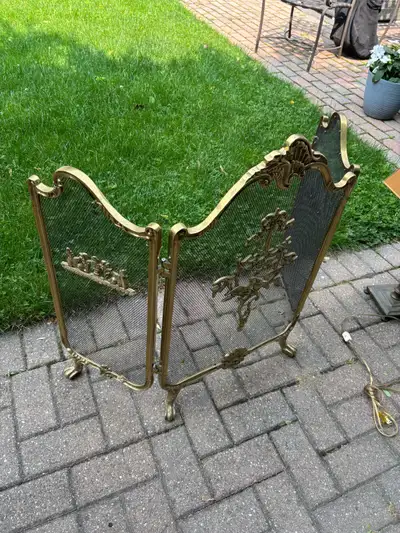 Add a touch of vintage elegance to your hearth with this ornate, bi-fold fireplace screen, featuring...